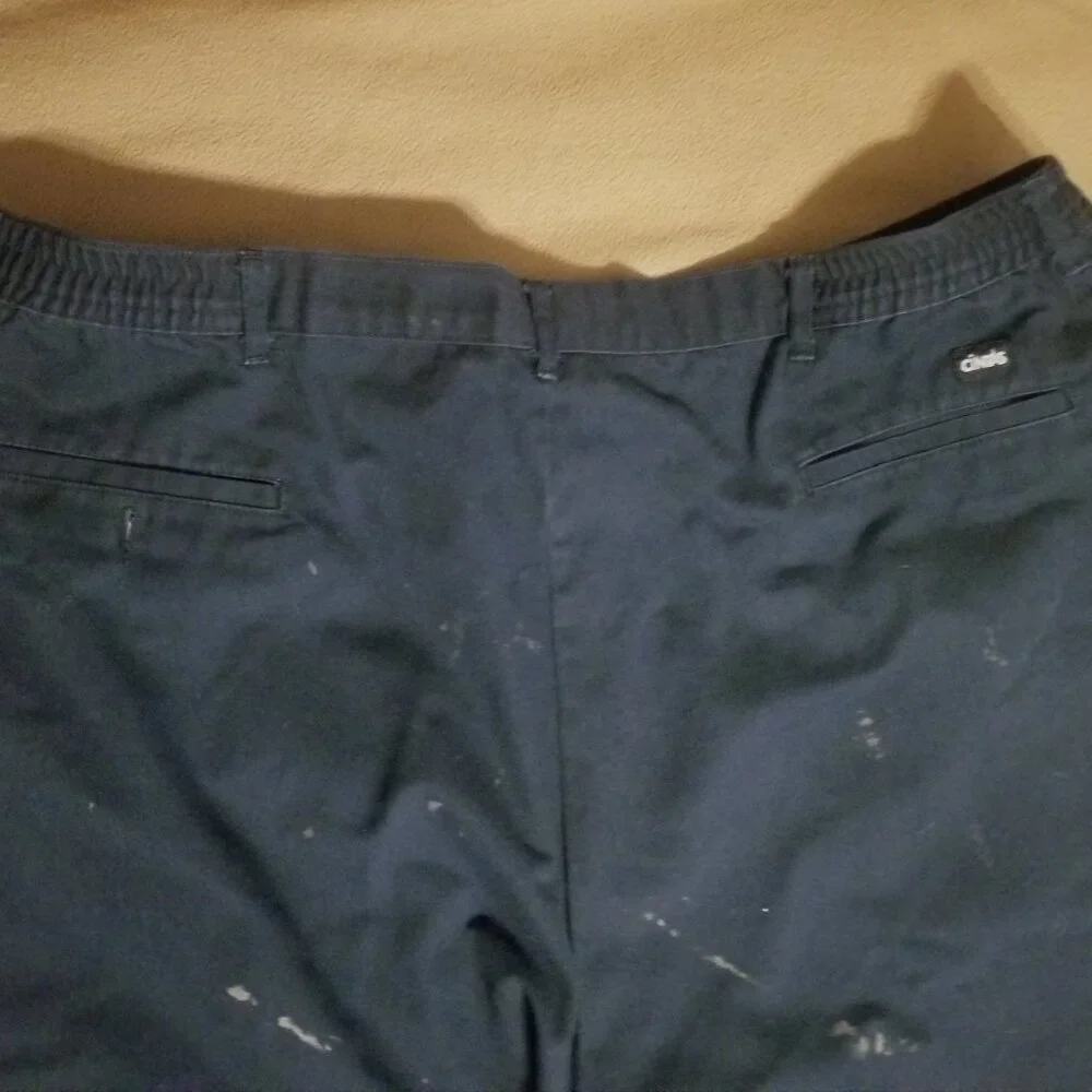 Three stained Cintas men's pants with stretching waistbands